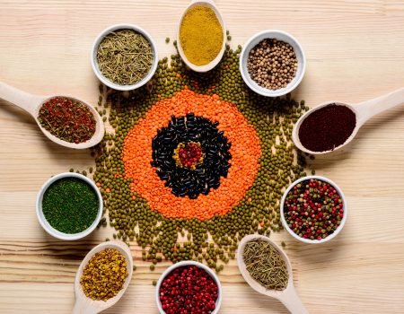 spices in spoons and on wooden table